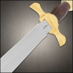 Close-up of dagger's blade and gold crossguard