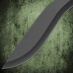 Close-up of a black sword blade on a green textured background