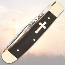 Closed pocket knife with cross design on black handle