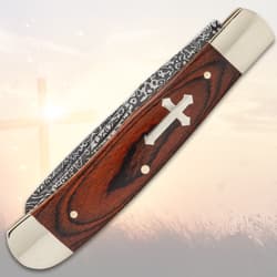Closed pocket knife with cross inlay on handle