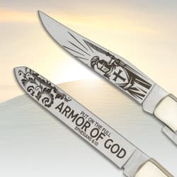 Close-up of knife blades with religious engravings