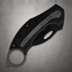Closed black folding knife with pocket clip and textured grip