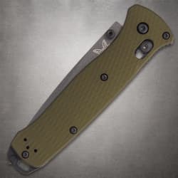 Closed Benchmade knife with green handle on gray surface