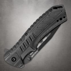Folded Black Legion pocket knife with a patterned black handle, finger grooves and visible blade cutouts