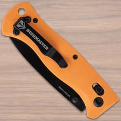 Folded knife with orange handle and black clip