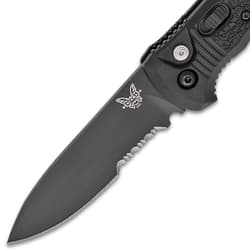 Close-up of a black serrated knife blade with logo