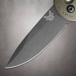 Close-up of a knife blade with logo engraving