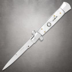 Open white stiletto knife with pearl handle on gray background