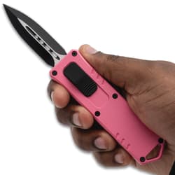 Hand holding a pink tactical knife
