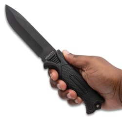 Hand holding a black tactical knife