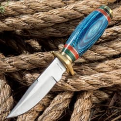 Knife with blue handle on coiled rope