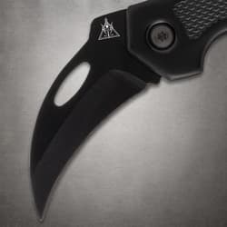 Close-up of black knife blade with logo