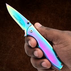 Hand holding a rainbow-finish folding knife