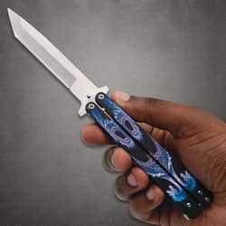 Hand holding butterfly knife with dragon design