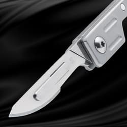 Close-up of the blade of a silver folding knife with Tanso branding
