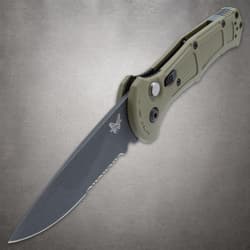 Open olive drab knife with serrated blade