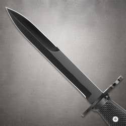 Black knife blade with textured handle on gray background