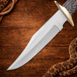 Close-up of knife blade with sharp edge on wooden background