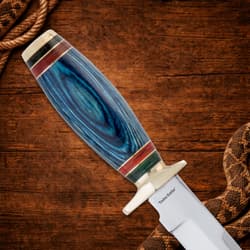 Close-up of knife handle on wooden background