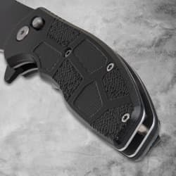 Close-up of black knife handle with textured grip