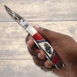 Hand holding knife with car design on handle