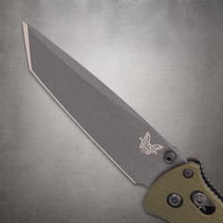 Close-up of gray knife blade with logo on textured background
