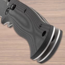 Close-up of textured black knife handle on wood surface