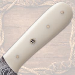 Close-up of cream knife handle with rivets