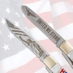 Close-up of knife blades with 'United We Stand' and patriotic engravings