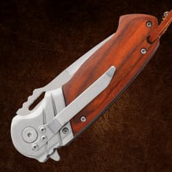 Folded Timber Wolf pocket knife showing clip and wood handle