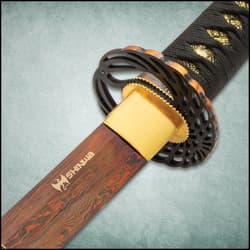 The 39 1/2” overall katana slides into a hand-lacquered, black scabbard, which features cavalry hanging hardware and cord-wrapping