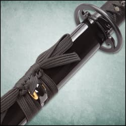 The black faux ray skin handle is wrapped in black cord.