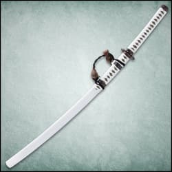 The handle is wrapped in gold-threaded cloth and white cord and has a cast metal pommel with a Samurai theme