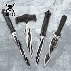 Four tactical knives with black handles on a textured background