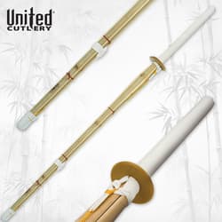 Bamboo shinai sword with white handle and guard on bamboo background