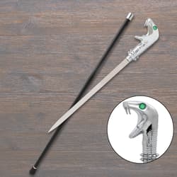 Sword cane with silver snake-head handle on wood surface