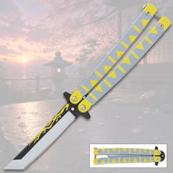 Butterfly knife with yellow and gray handle, scenic background