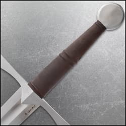 Close-up of sword handle with brown grip and round pommel