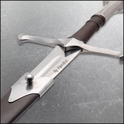 Close-up of sword hilt with brown grip and crossguard