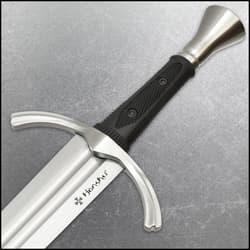 Close-up of sword handle and guard on gray surface