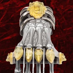 Front view of claw weapon with detailed wolf and lion carvings
