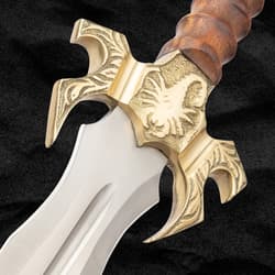 Close-up of sword's brass handguard with scorpion design