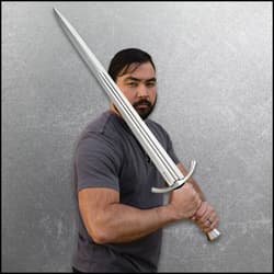 Person holding a broadsword in a defensive stance