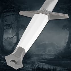 Sword pommel and hilt detail, dark forest backdrop