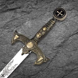 Detailed view of ornate sword hilt on stone surface