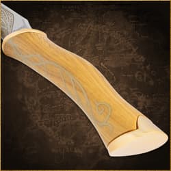 Close-up of a wooden knife handle with vine motif