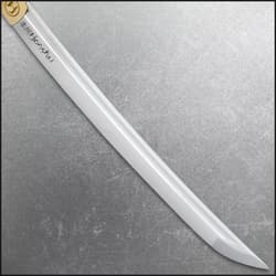 Close-up of tanto blade with engraved text on a textured background