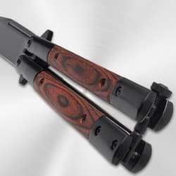 Close-up of butterfly knife's wood handle and latch