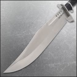 Close-up of knife blade showing sharp edge and engraved text