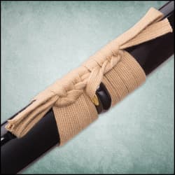 The tan cord of the handle wraps through the pommel of the katana.